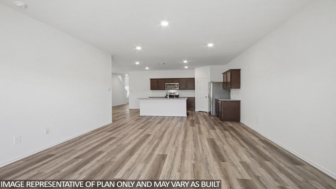 Living and dining space with vinyl flooring.