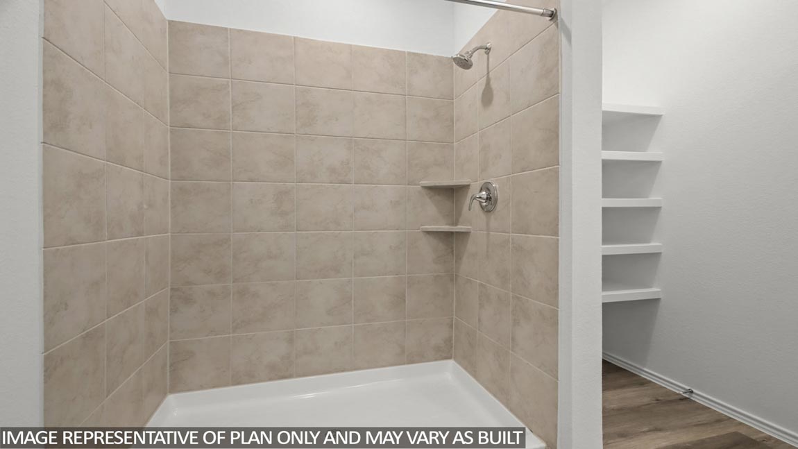 Primary bathroom with standing shower and linen nook.