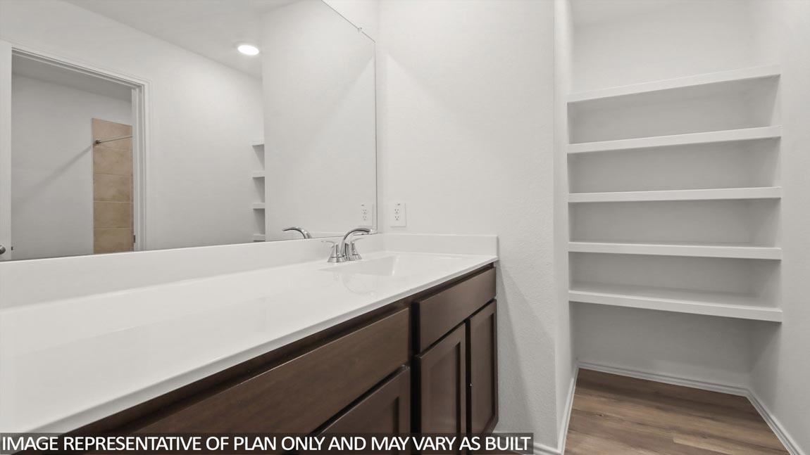 Secondary bathroom with double sink and linen nook.