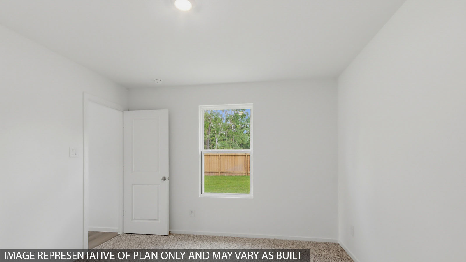 Primary bedroom with carpet flooring