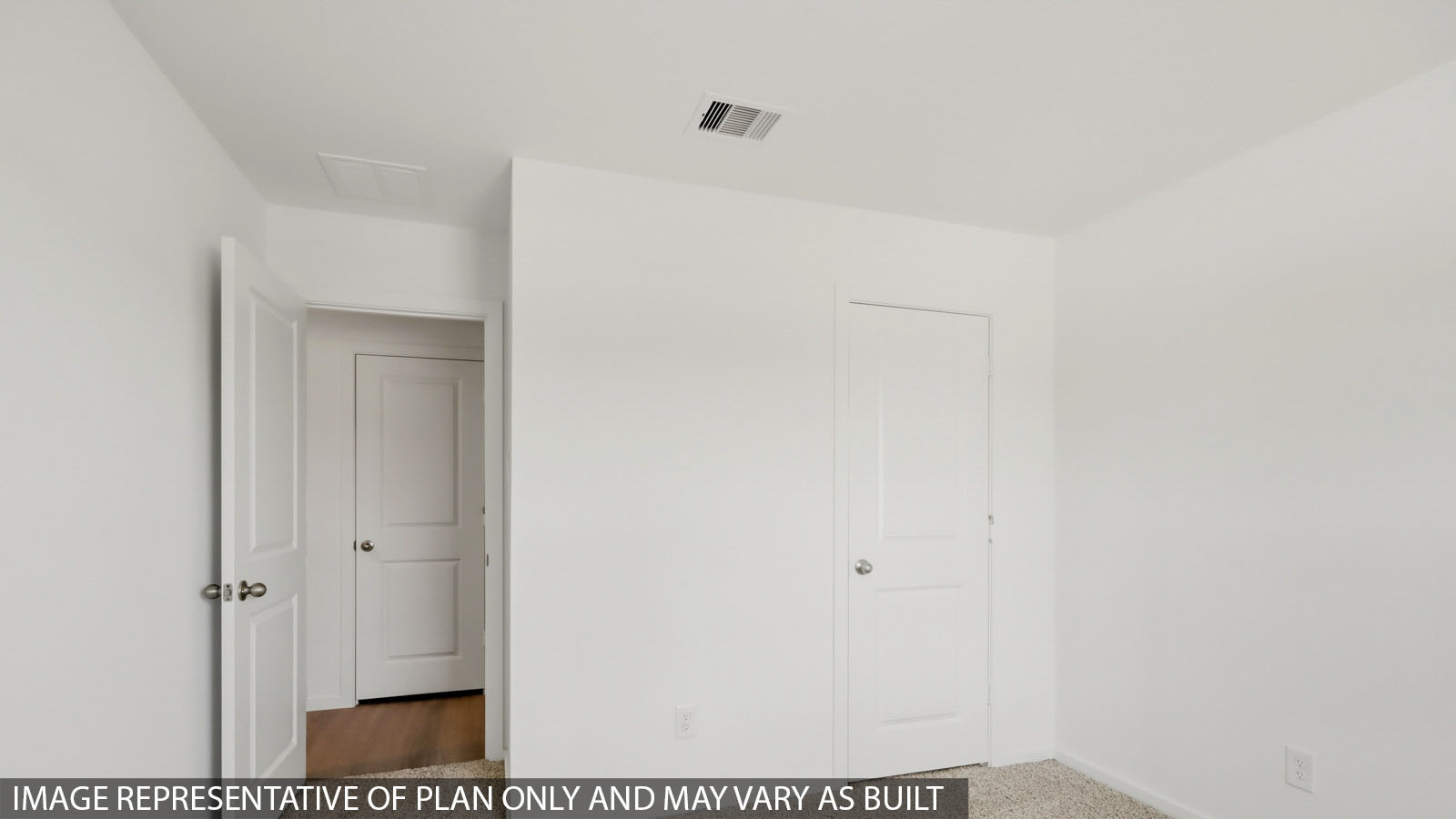 Secondary bedroom with carpet flooring