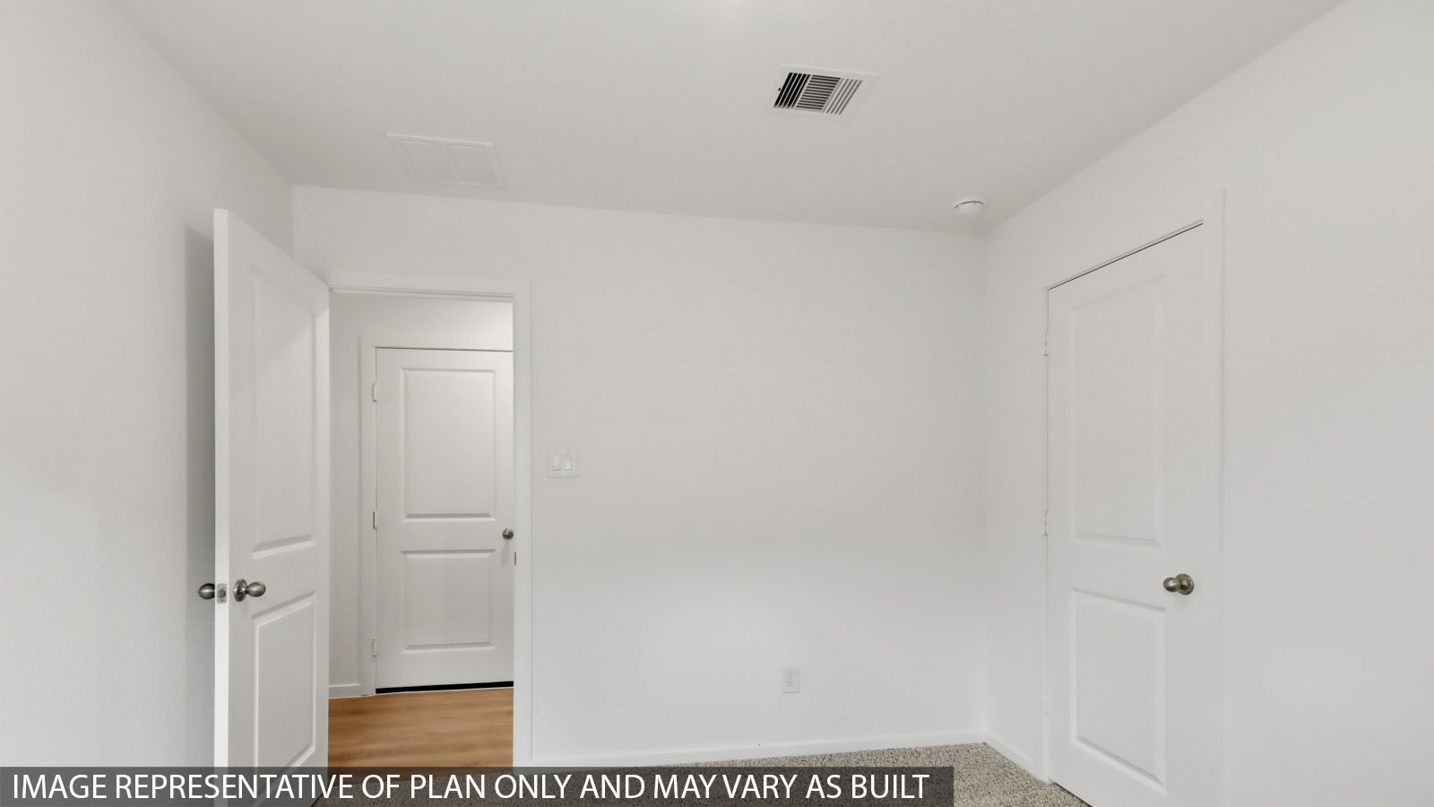 Secondary bedroom with carpet flooring