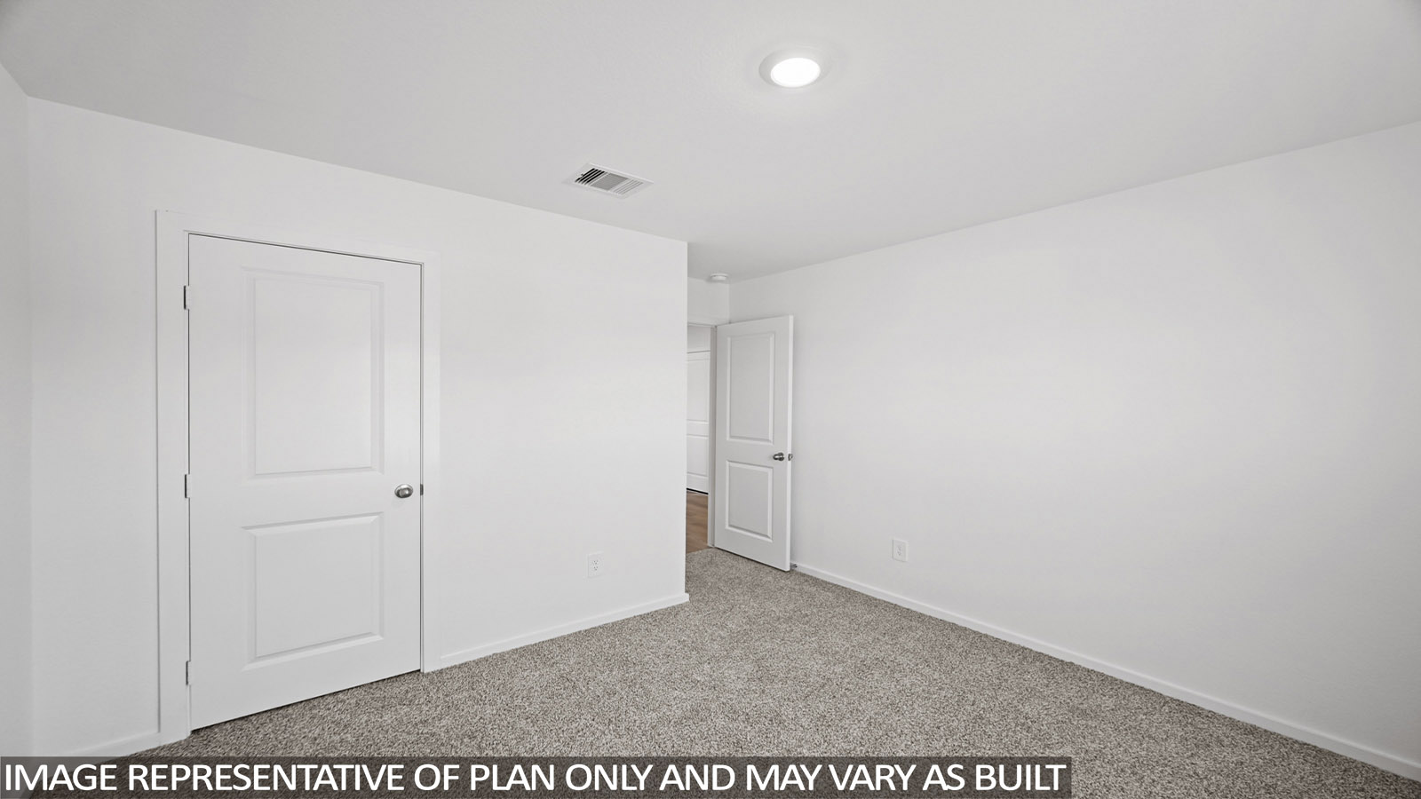 Secondary bedroom with carpet flooring