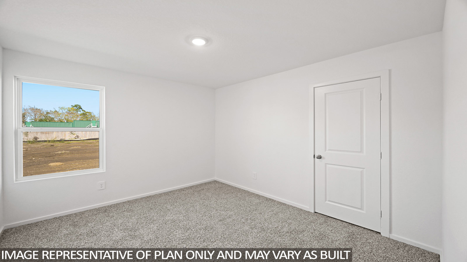 Secondary bedroom with carpet flooring