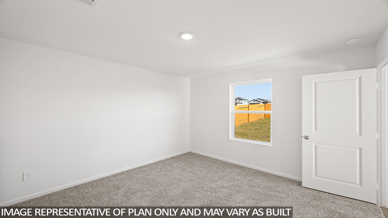 Primary bedroom with carpet flooring