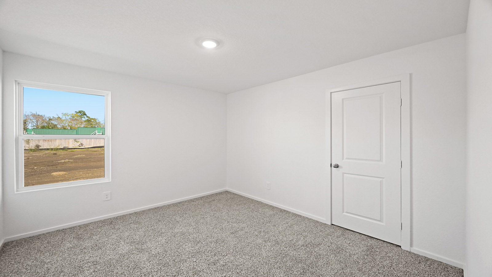 Secondary bedroom with carpet flooring