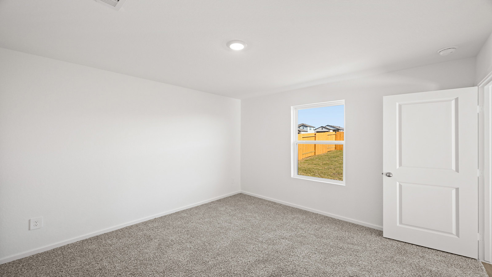 Primary bedroom with bright windows
