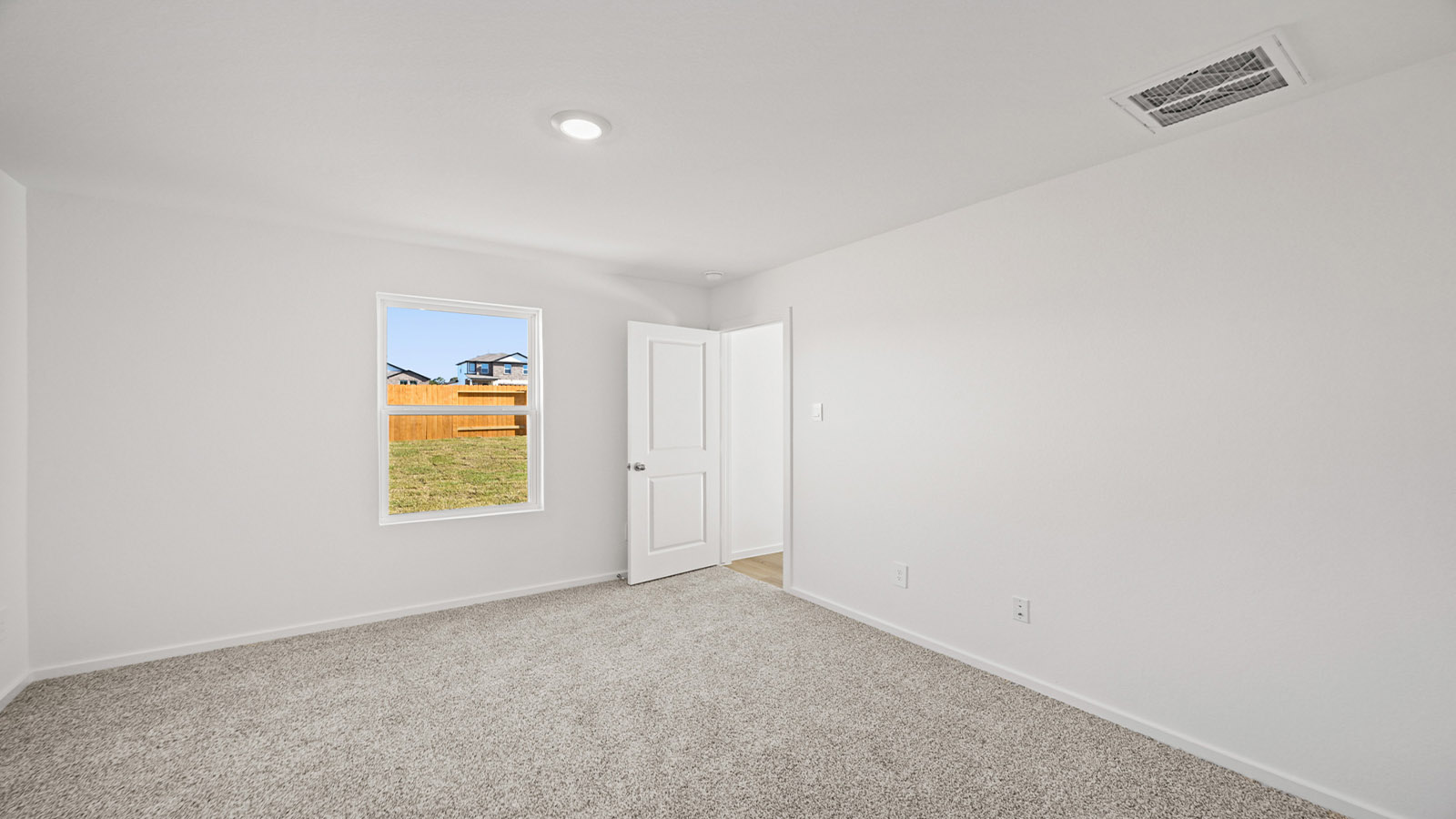 Primary bedroom with bright windows