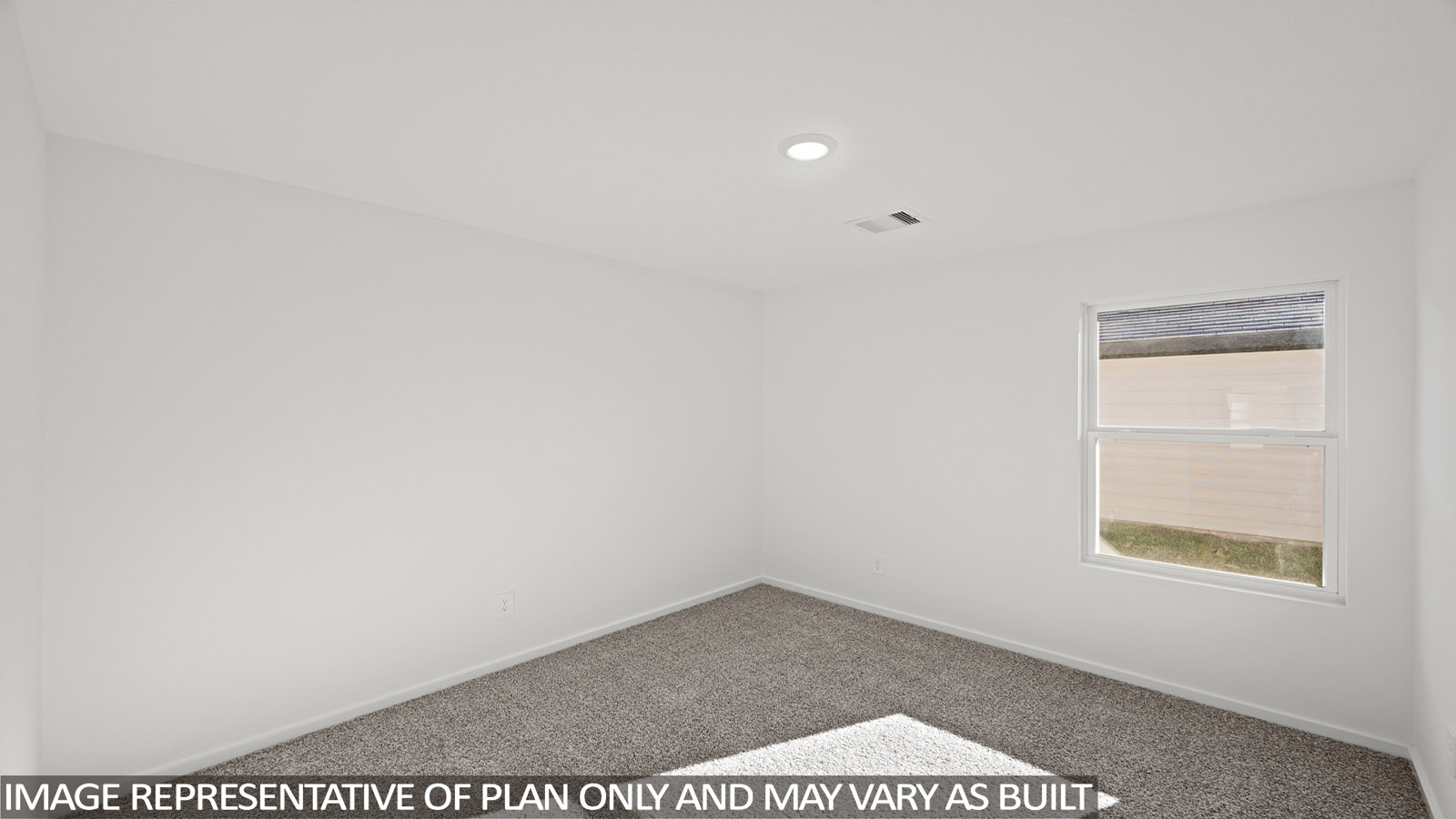 Secondary bedroom with carpet flooring