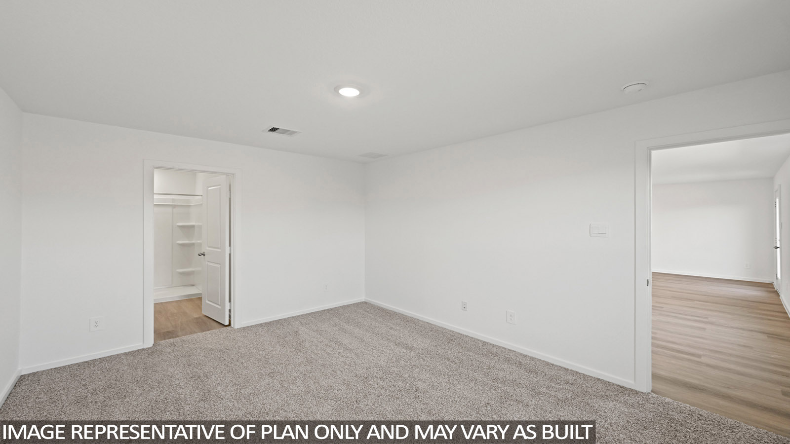 Primary bedroom with carpet flooring