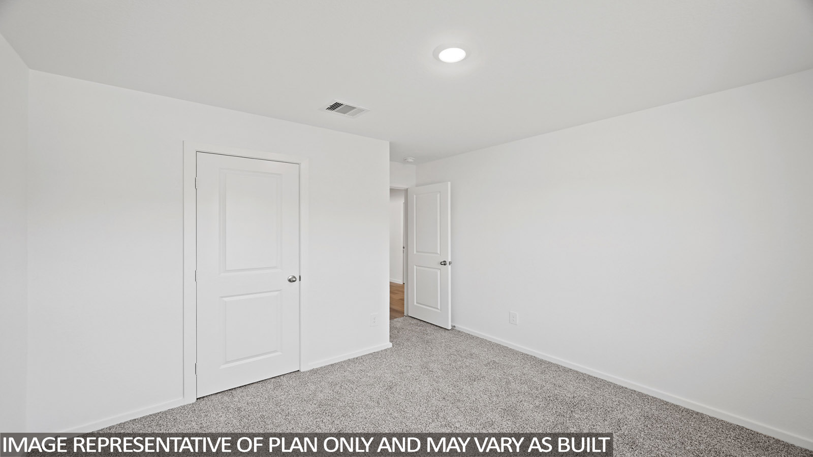 Secondary bedroom with carpet flooring