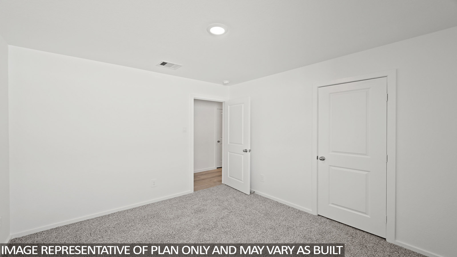 Secondary bedroom with carpet flooring
