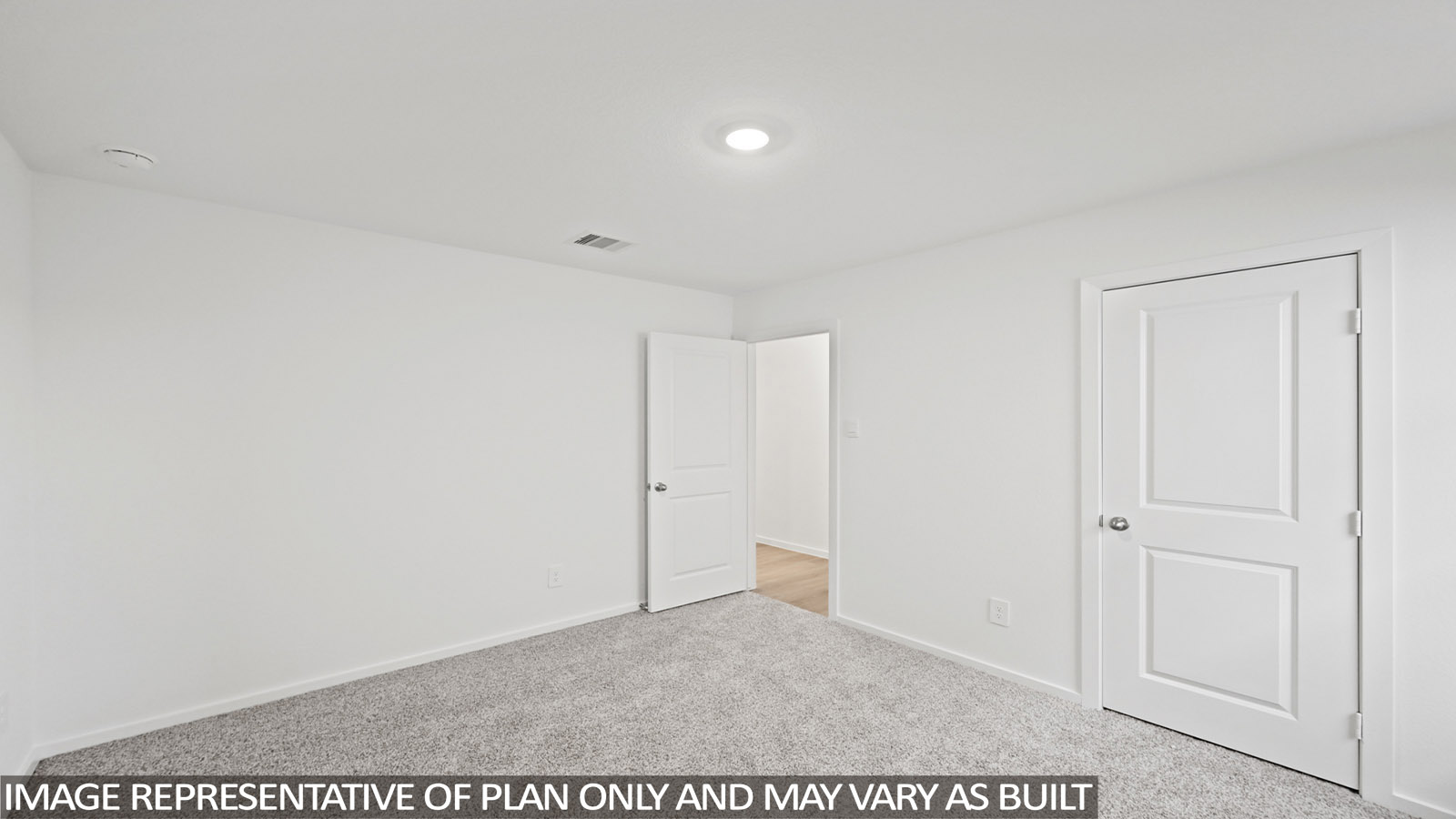 Secondary bedroom with carpet flooring