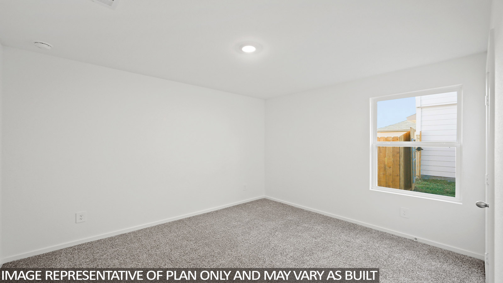 Secondary bedroom with carpet flooring