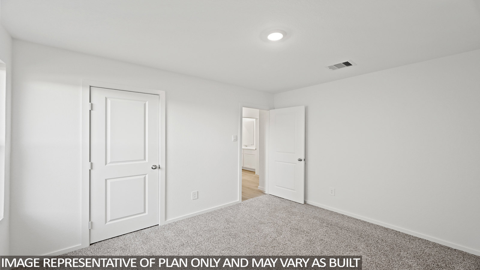 Secondary bedroom with carpet flooring