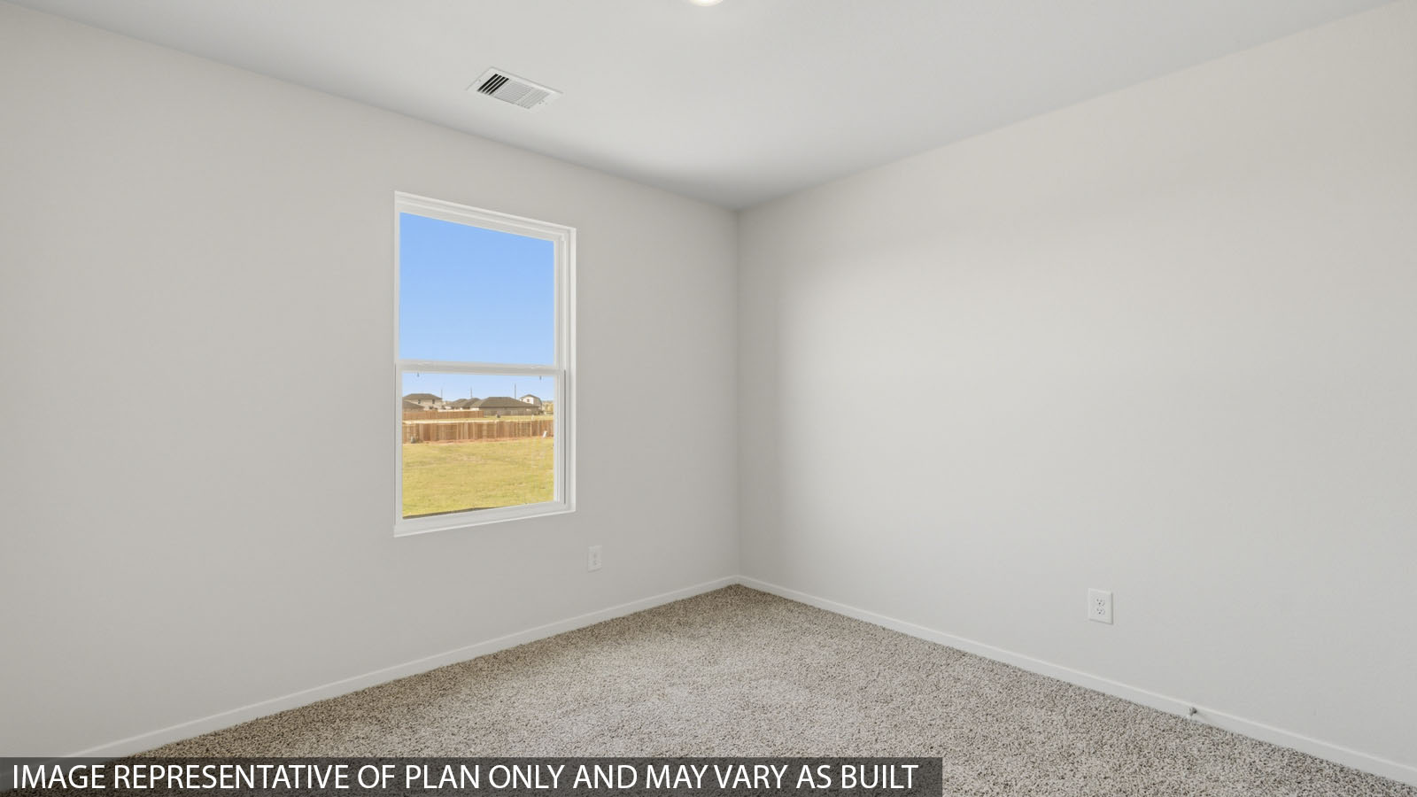 Secondary bedroom with carpet flooring