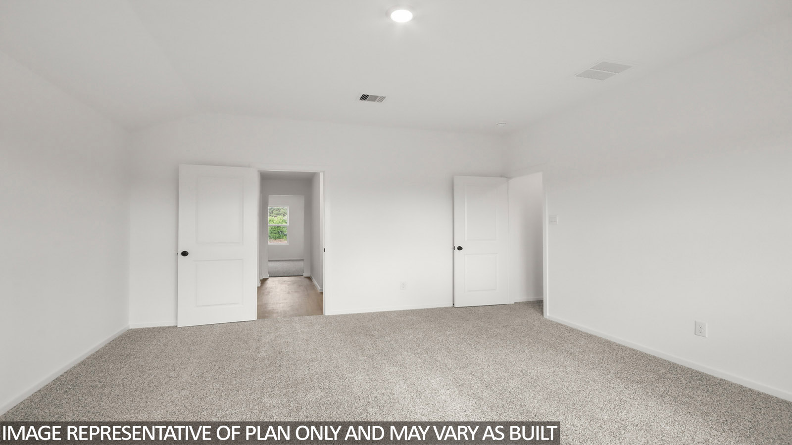 Primary bedroom with carpet flooring
