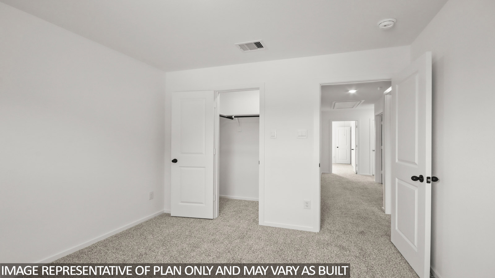 Secondary bedroom with carpet flooring