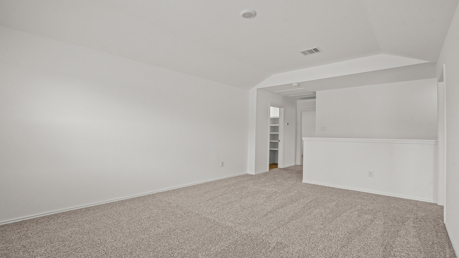 Second story game room with carpet flooring
