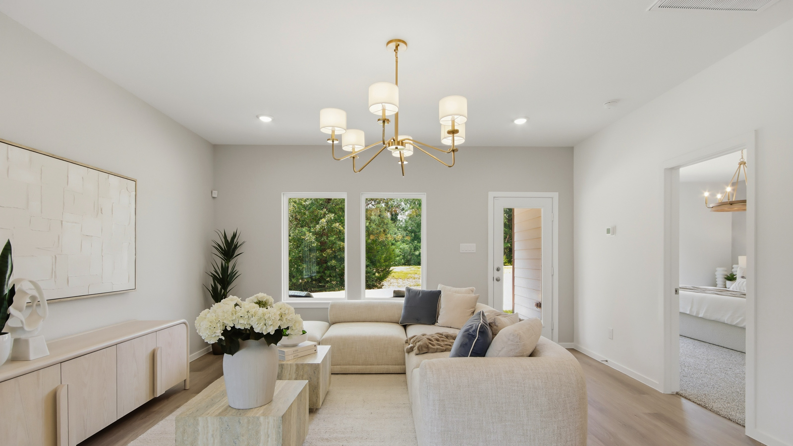 Spacious living area with vinyl flooring
