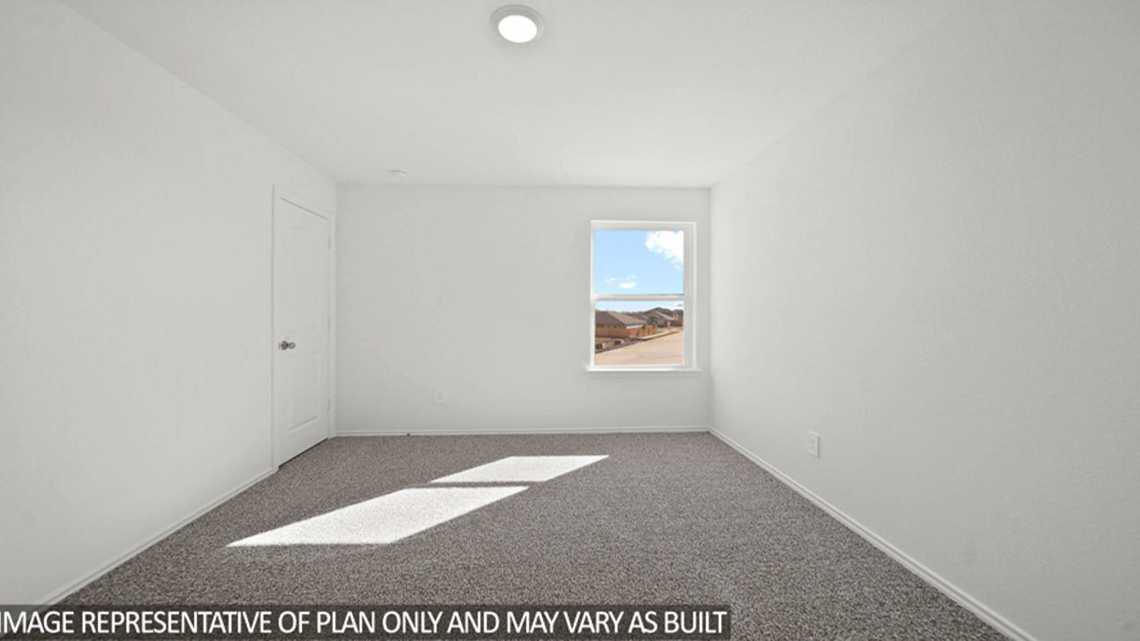 Secondary bedroom with carpet flooring