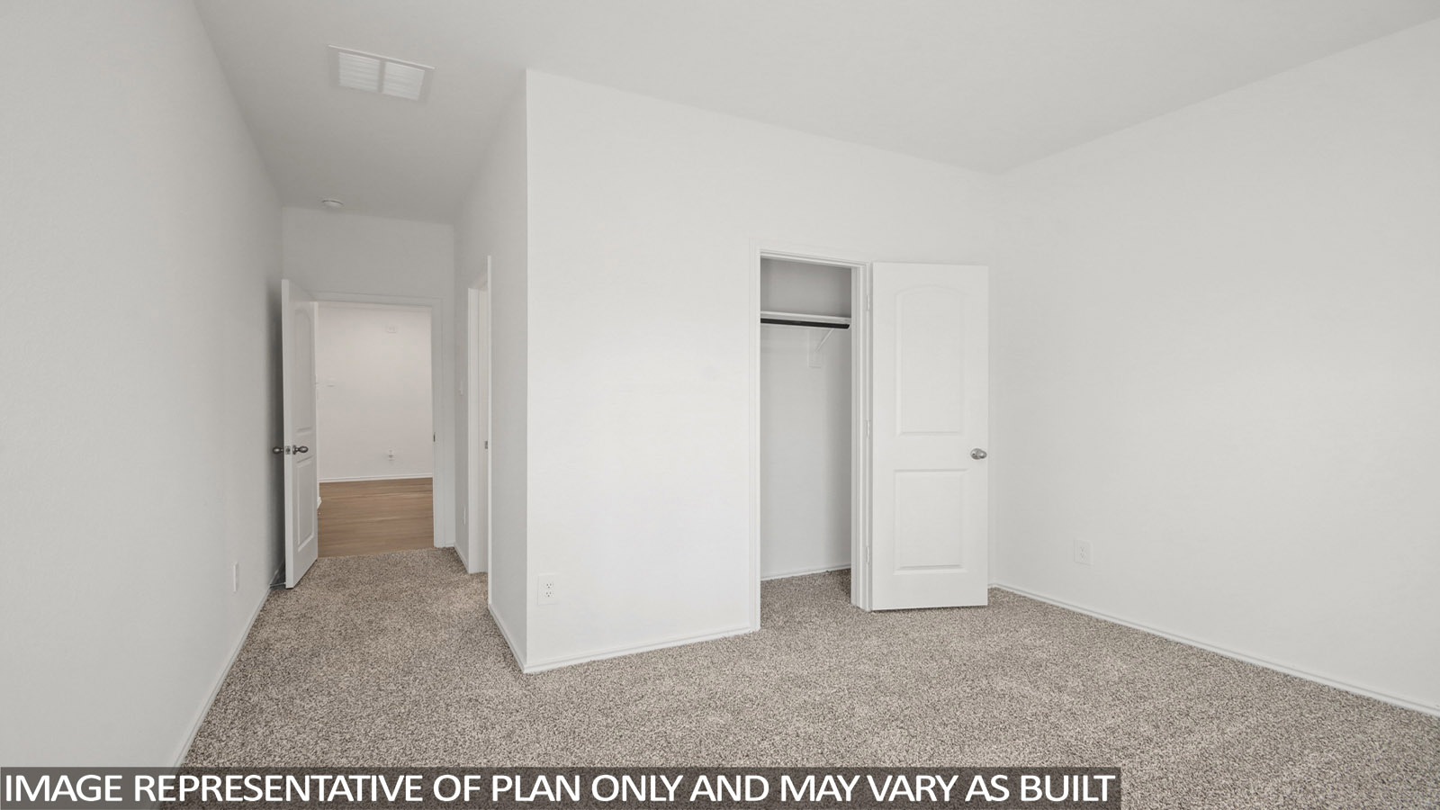 Secondary bedroom with carpet flooring