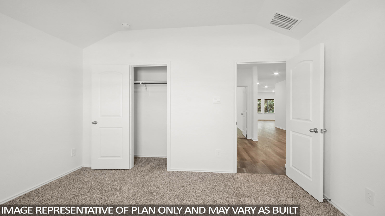 Secondary bedroom with carpet flooring