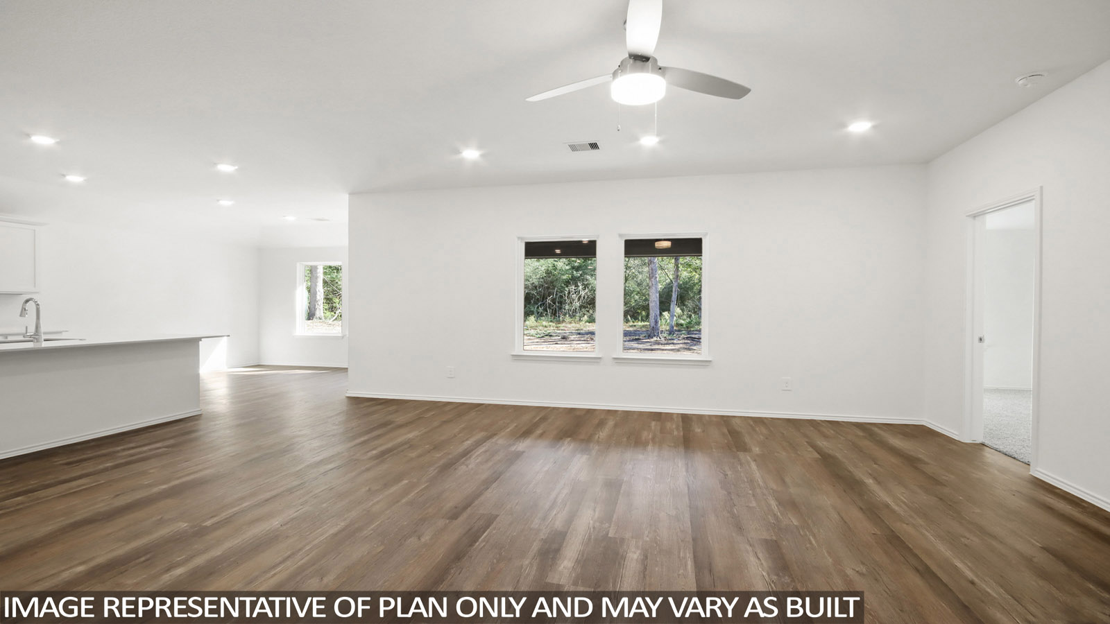 Spacious living area with vinyl flooring