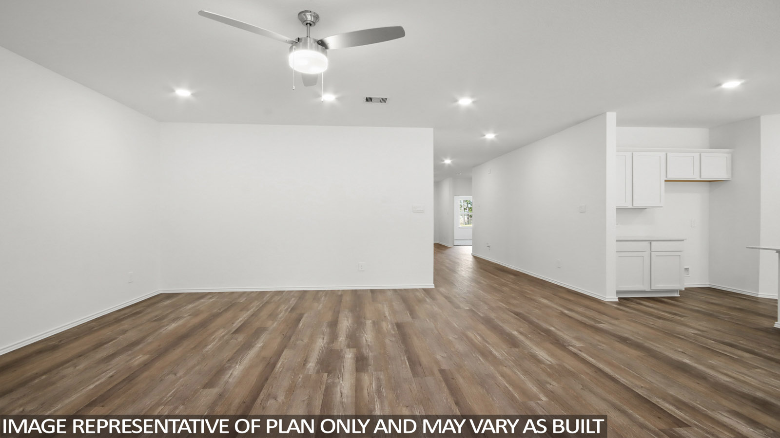 Spacious living area with vinyl flooring