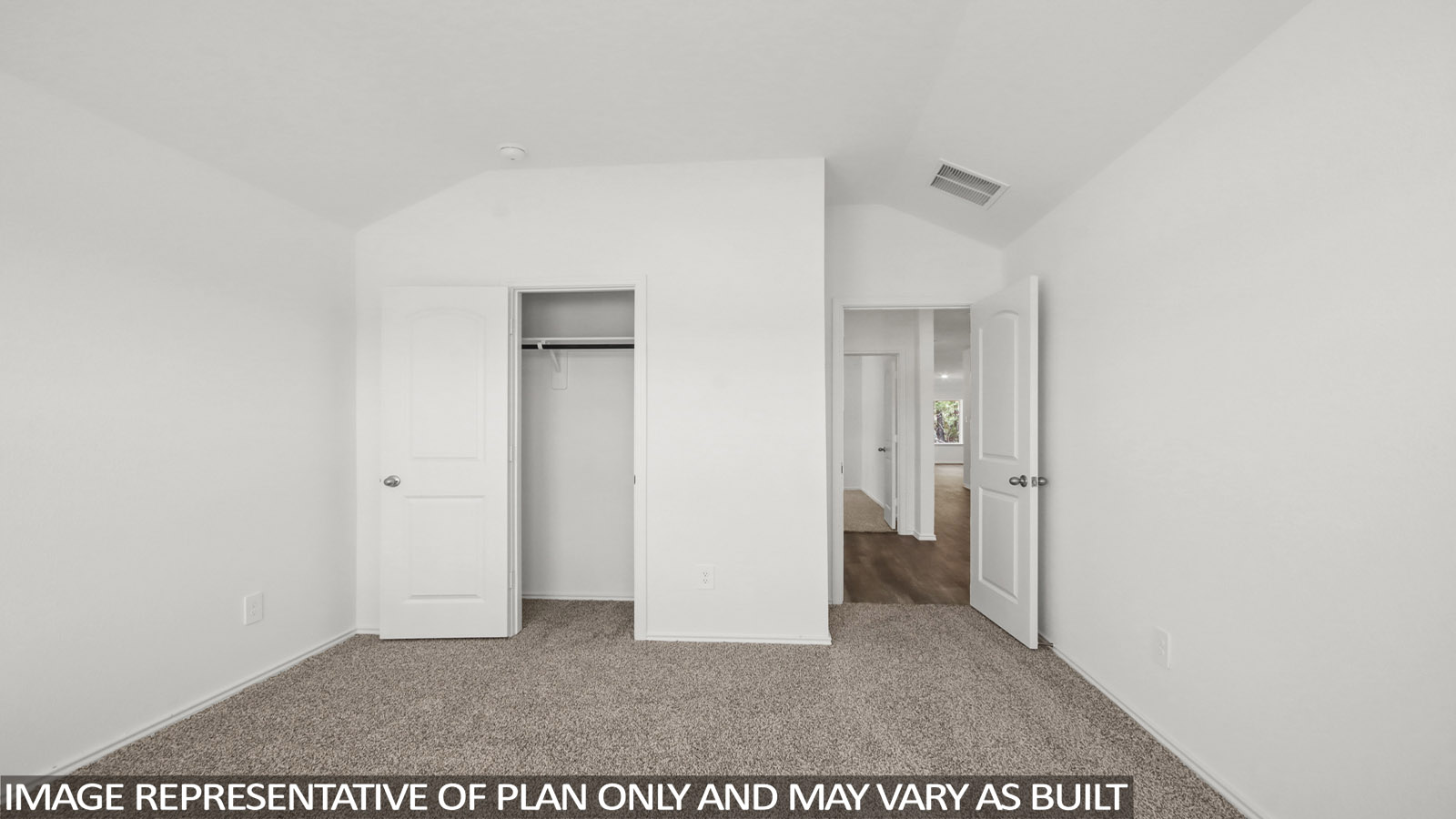 secondary bedroom with tall closet and carpet flooring