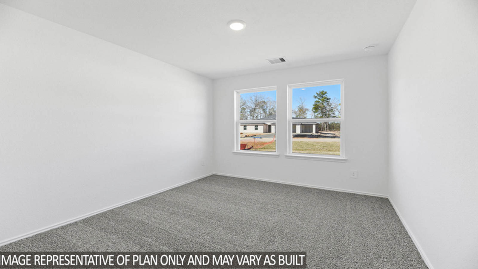 Secondary bedroom with carpet flooring
