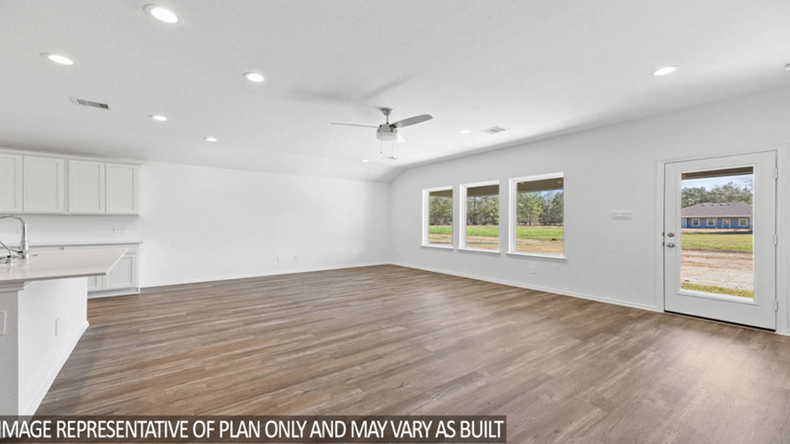 Spacious living area with vinyl flooring