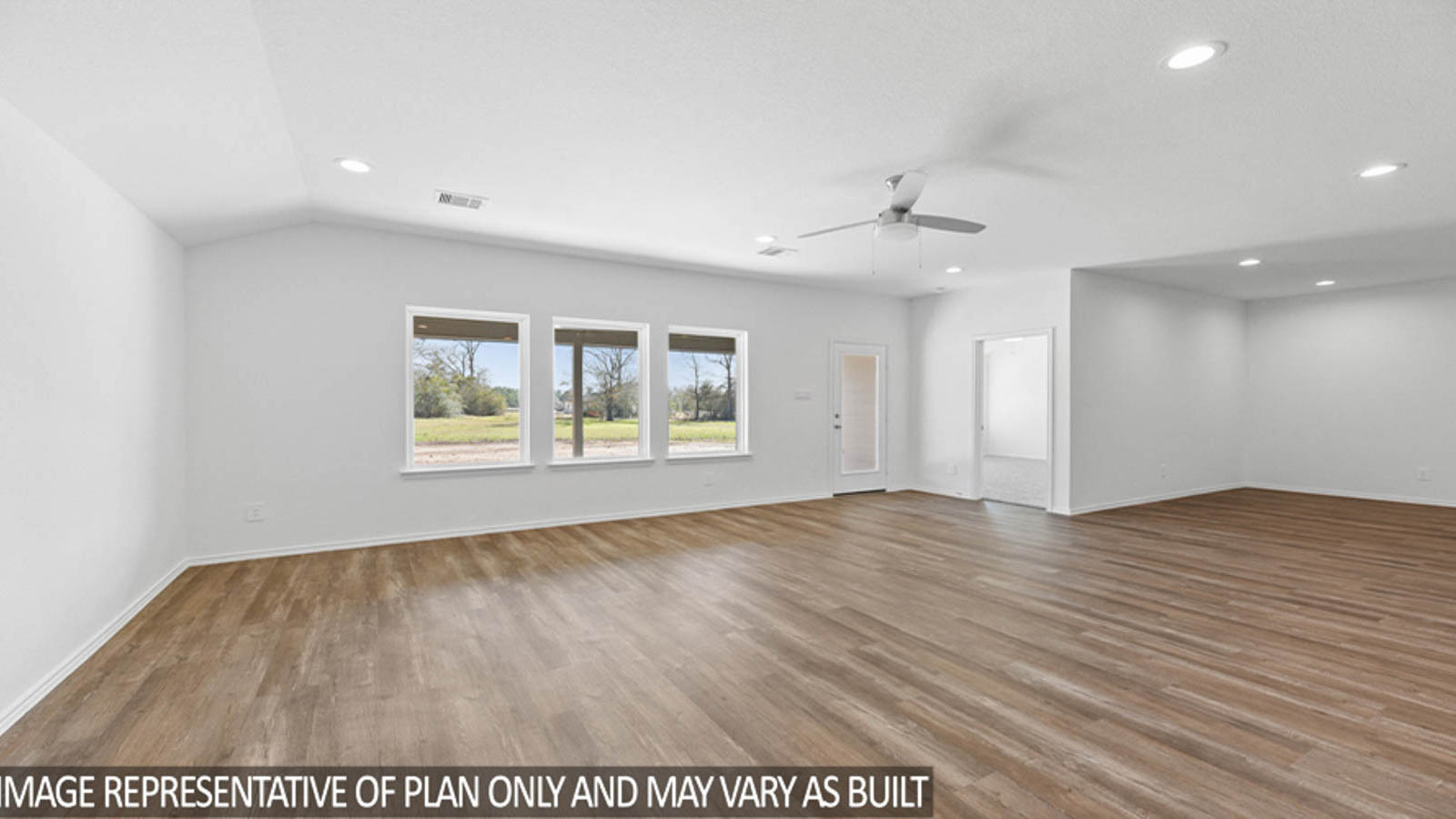 Spacious living area with vinyl flooring