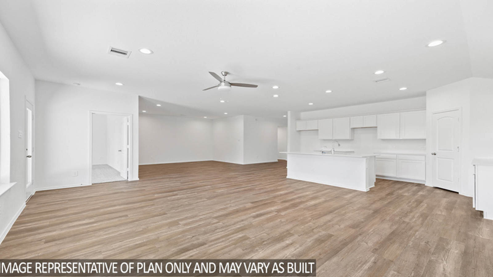 Open concept living and dining area with vinyl flooring and bright windows.