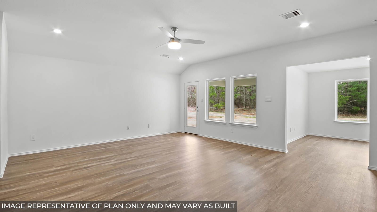 Open concept living and dining area with vinyl flooring and bright windows.