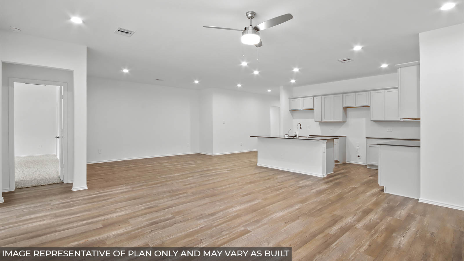 Open concept living and dining area with vinyl flooring and bright windows.