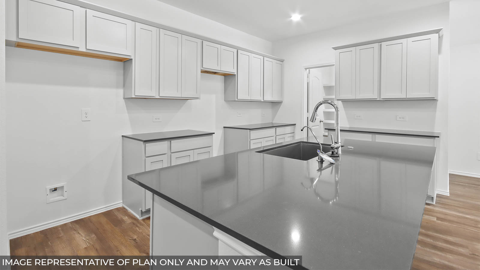 Kitchen with an island and a spacious pantry.