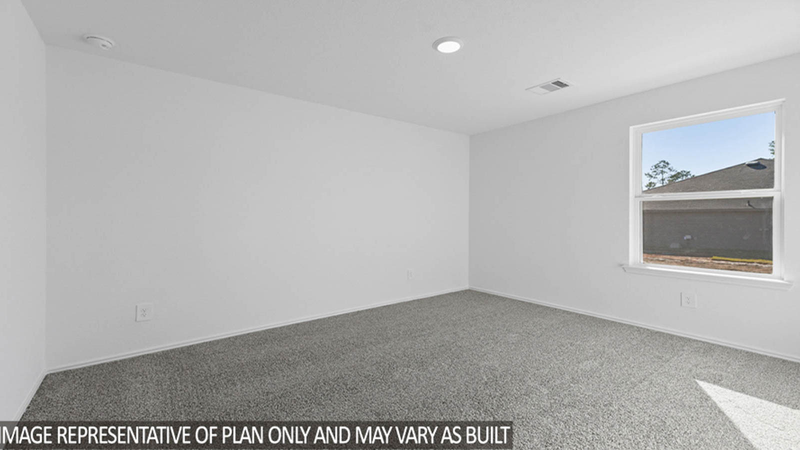 Secondary bedroom with carpet flooring