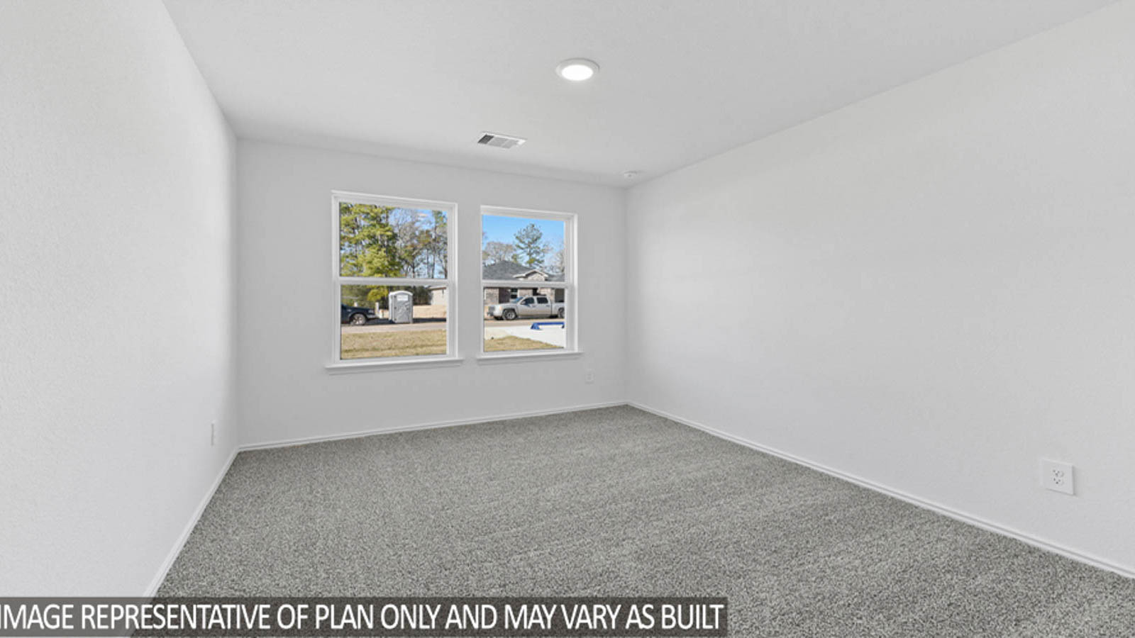 Secondary bedroom with carpet flooring