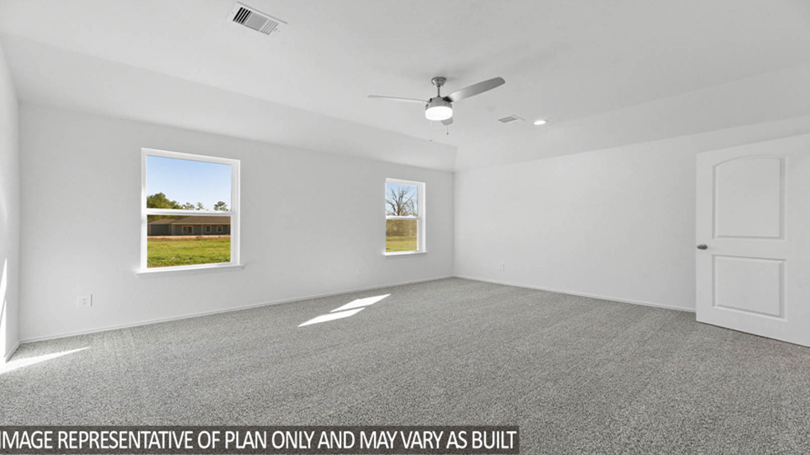 Primary bedroom with carpet flooring