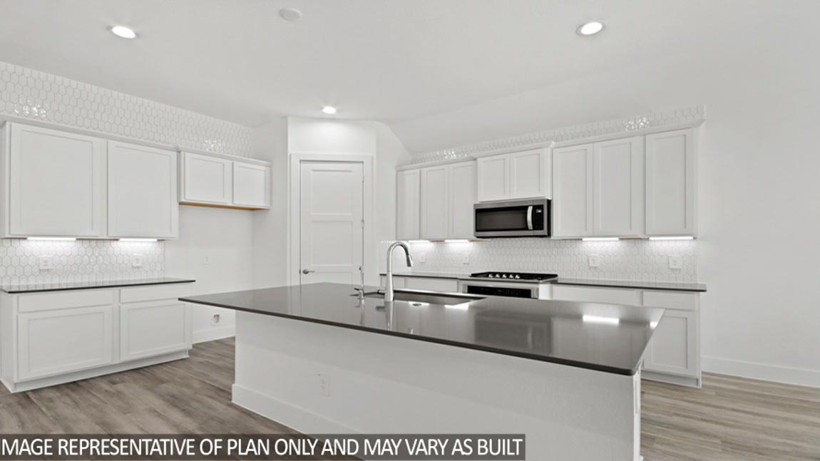 Kitchen with an island and vinyl floor