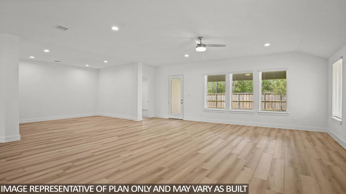 Spacious living area with vinyl flooring