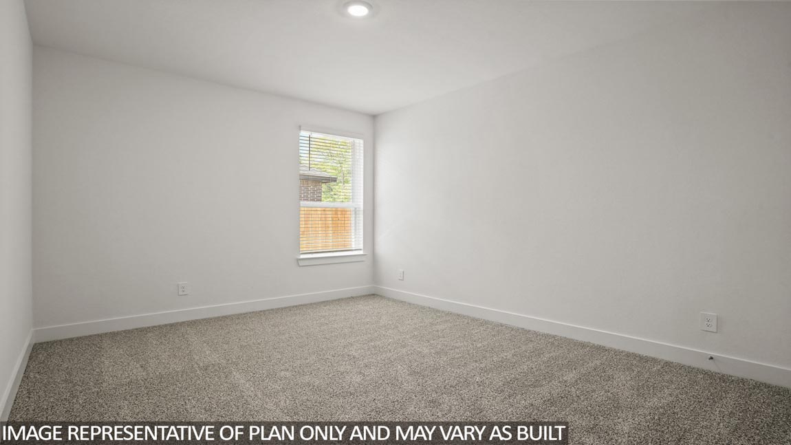 Secondary bedroom with carpet flooring