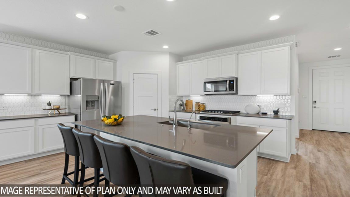 Kitchen with an island and vinyl floor