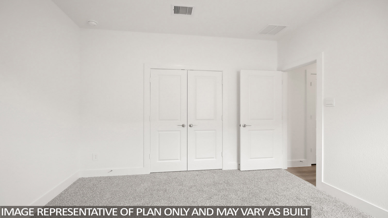 Secondary bedroom with carpet flooring