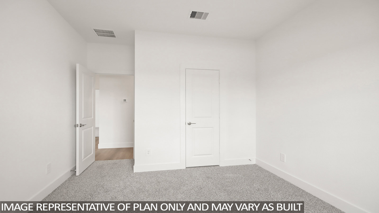 Secondary bedroom with carpet flooring