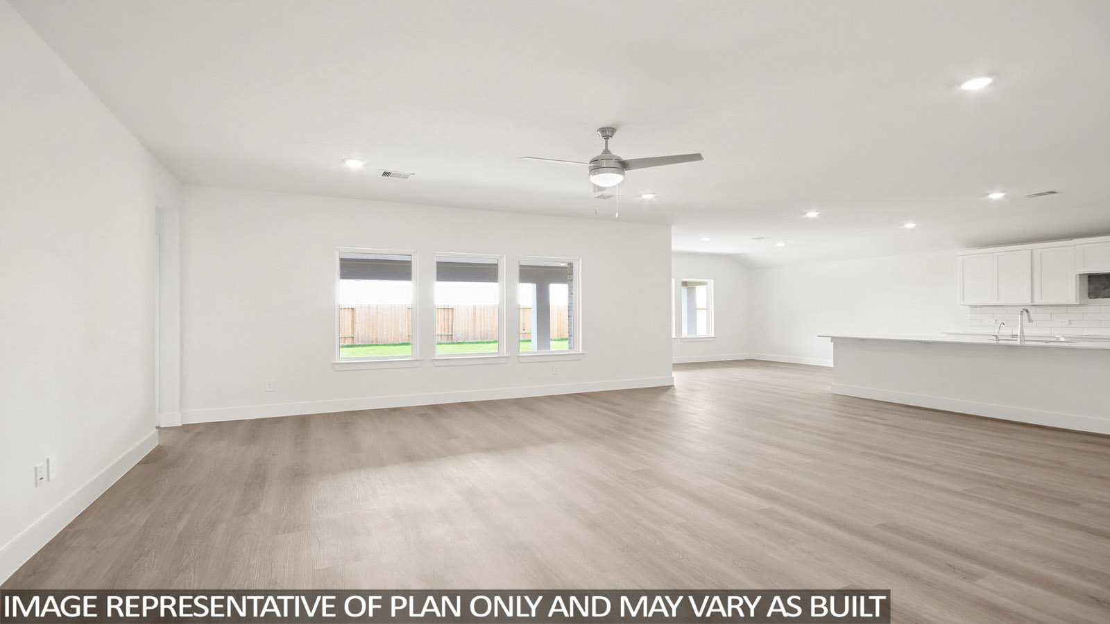 Spacious living area with vinyl flooring