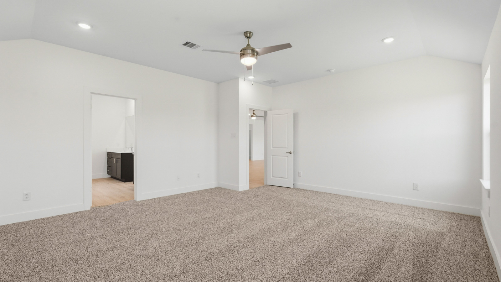 Primary bedroom with bright windows