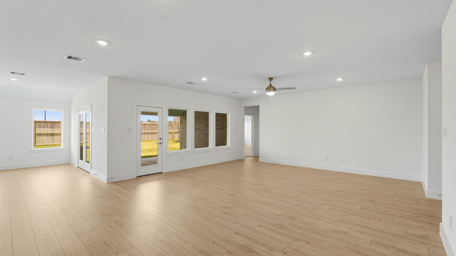 Spacious living area with vinyl flooring