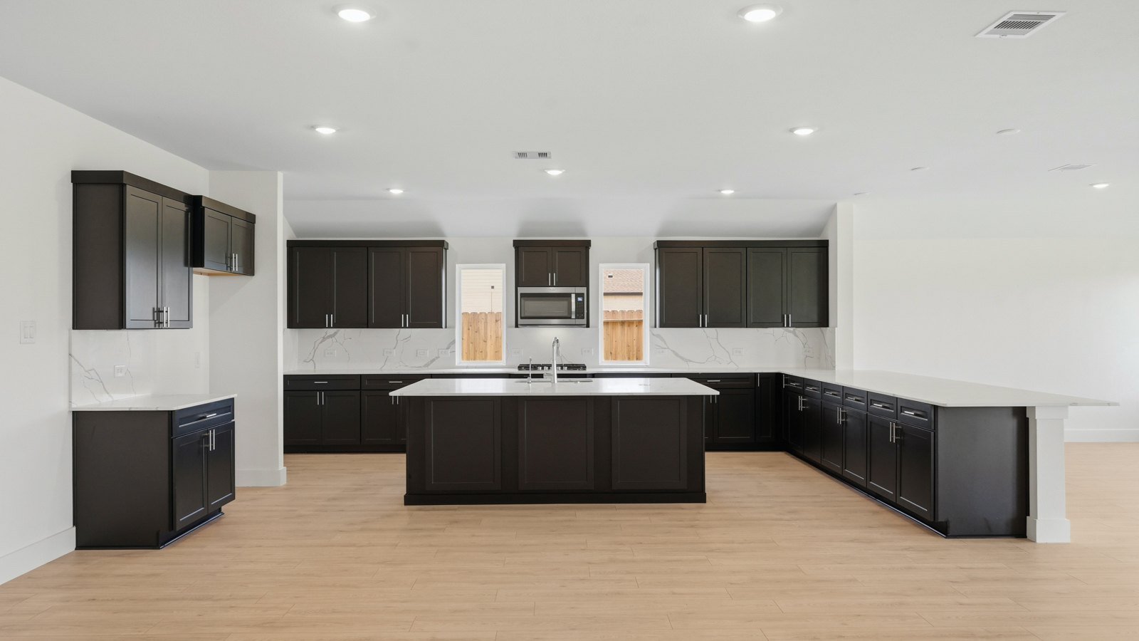 Kitchen with an island and vinyl floor